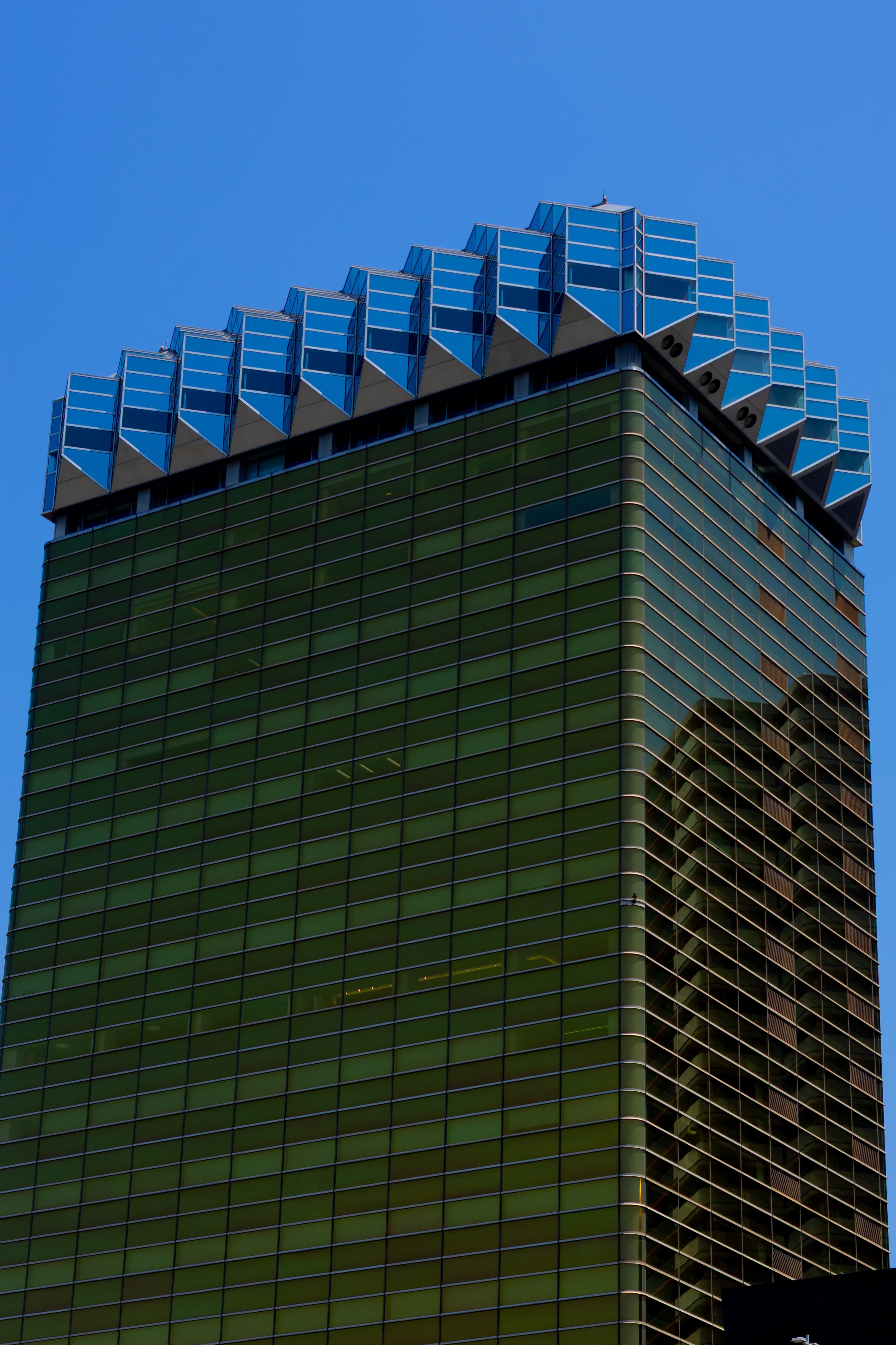 Glass office tower against a clear sky